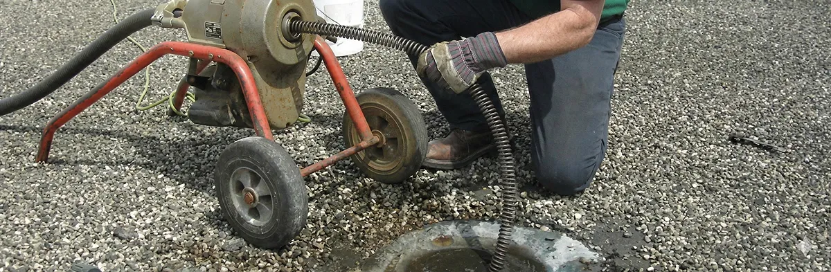 sewer rodding technician actively removing blockages from a sewer line in Aurora, CO